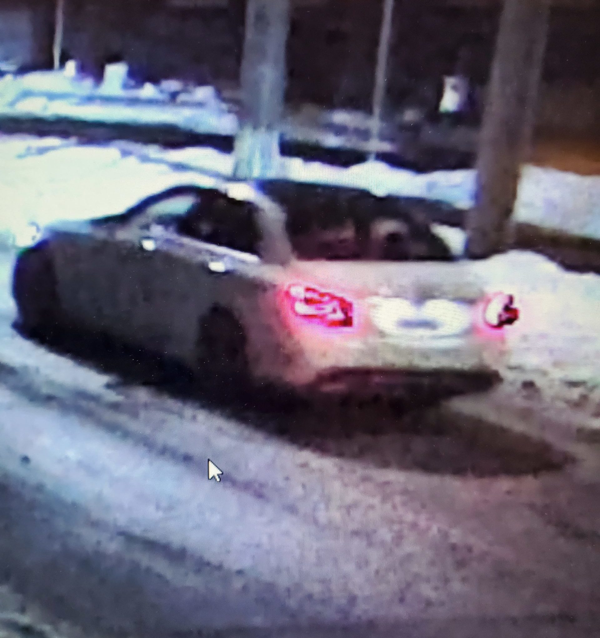 A white Mercedes C300 drives in the snow.