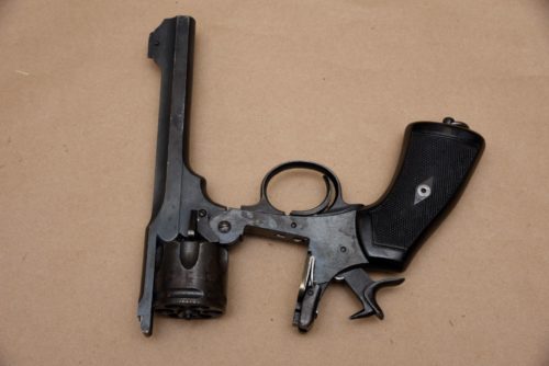 a firearm is opened and placed on brown paper.