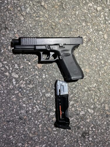 A firearm on the pavement.