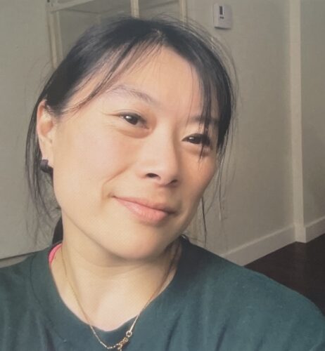 Laura wears a green shirt.