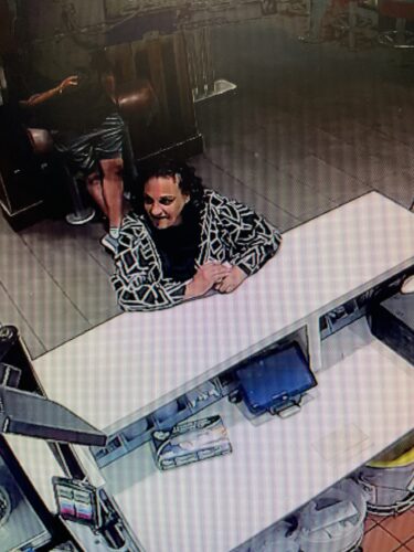 A suspect in an assault investigation. The female has brown hair and a black and white top.