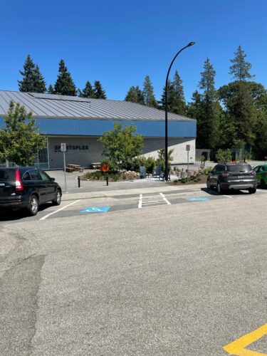 Two accessible parking spaces in front of the New Wet Sportsplex.