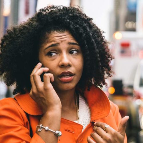 a woman calls for police on her phone