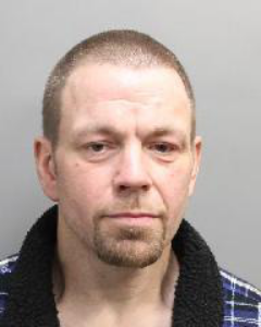 Gregory Meilleur is shown with a blue plaid shirt and short hair.