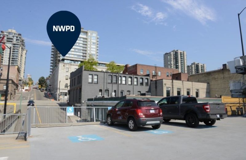 A photo from the Sixth Street parkade shows three accessible parking spaces. The police department is shown in the background with a blue icon.
