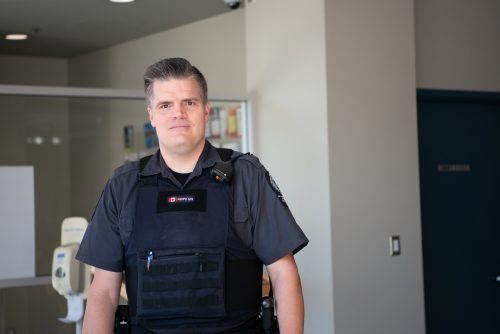 Special Constable Frayle stands inside the New Westminster Police Department. 